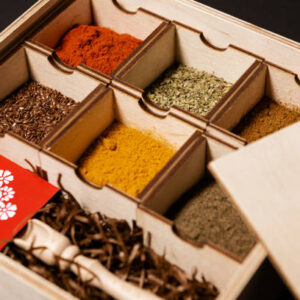 Various spices in boxes on a black background
